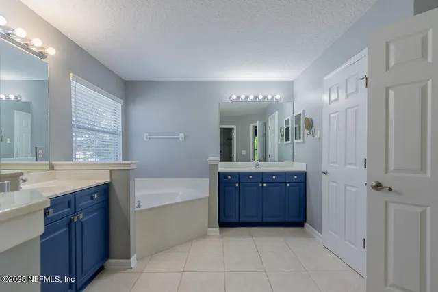 a bathroom with a sink double vanity shower and a bathtub