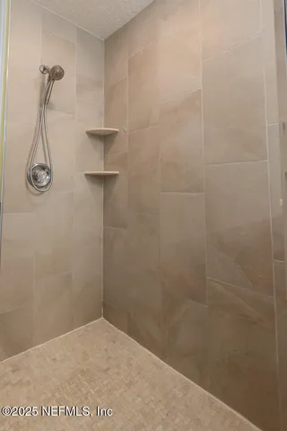 an empty room with a ceiling fan and a window