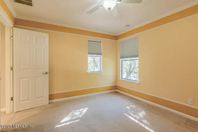 an empty room with a ceiling fan