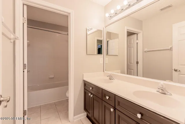 a bathroom with a sink a mirror and a vanity