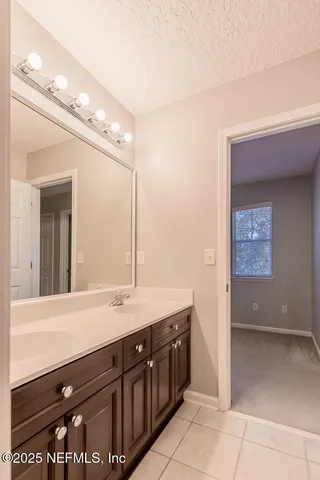 an empty room with closet and a chandelier fan