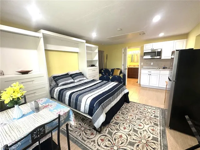 a spacious bedroom with double bed and a window