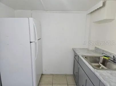 a kitchen with a sink and refrigerator