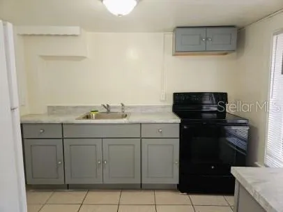 a kitchen with a sink and cabinets