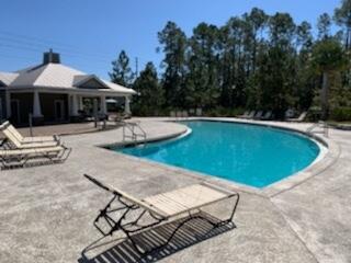 328 North Sand Palm Road Freeport, FL 32439 - Photo 6 of 13 a view of a swimming pool with lounge chair