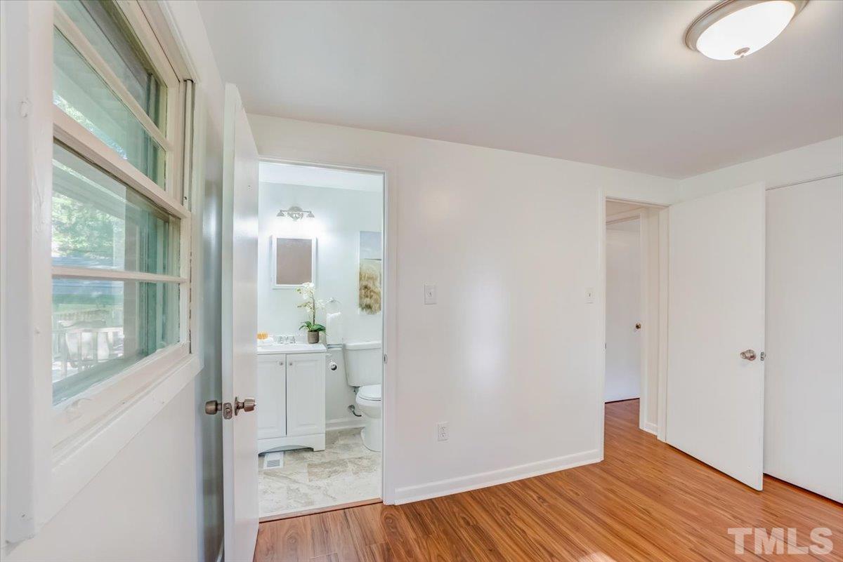 424 Grovemont Road Raleigh, NC 27603 - Photo 13 of 23 a view of a room with wooden floor and windows