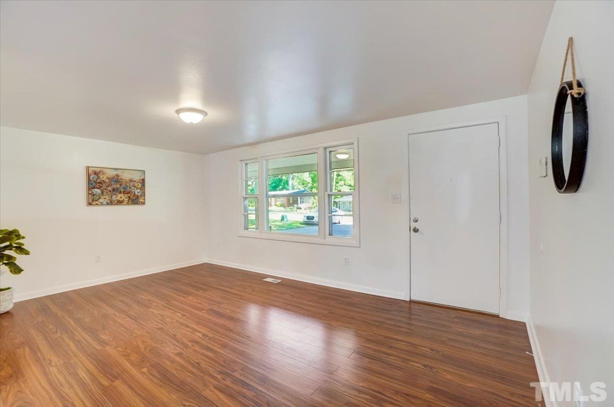424 Grovemont Road Raleigh, NC 27603 - Photo 5 of 23 wooden floor in an empty room with a window