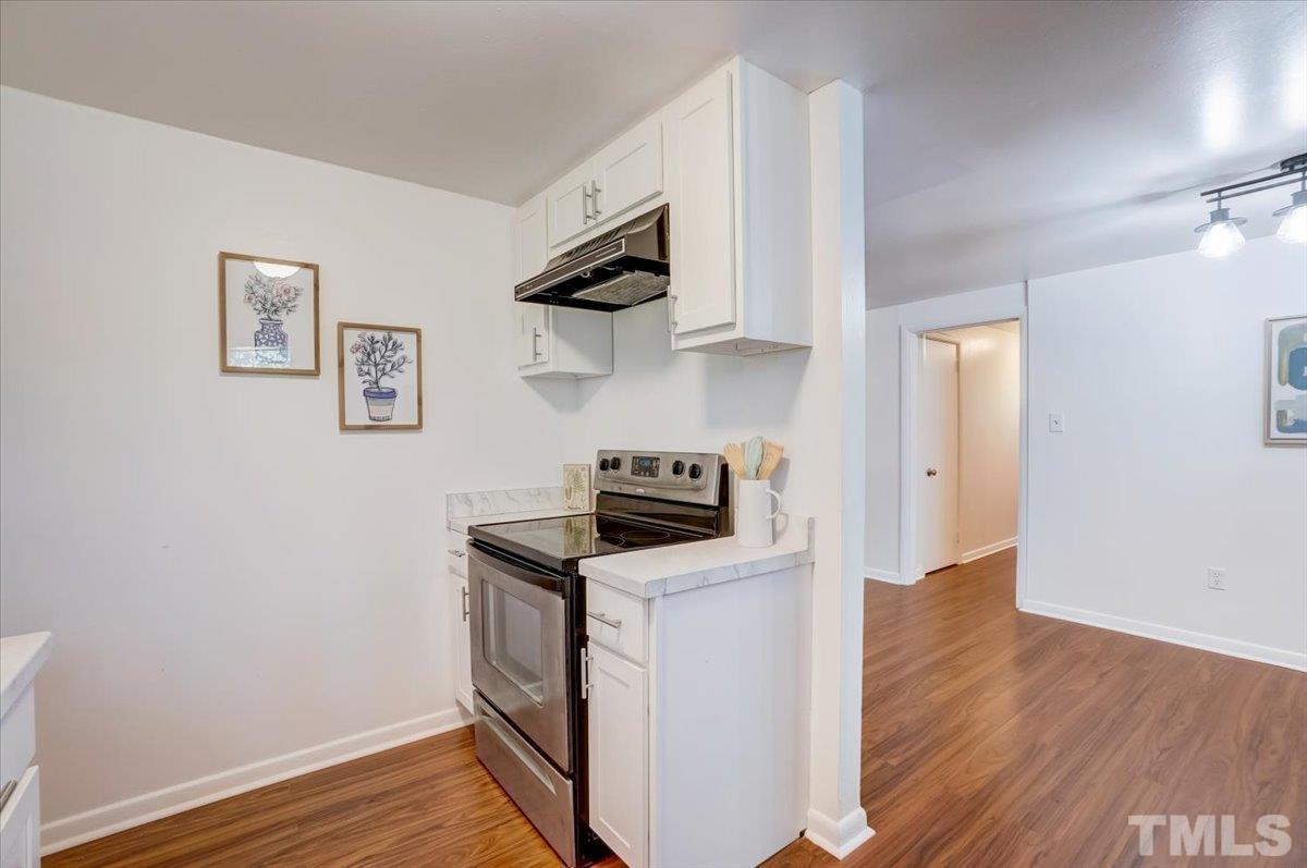 424 Grovemont Road Raleigh, NC 27603 - Photo 9 of 23 a kitchen with granite countertop a stove top oven and sink