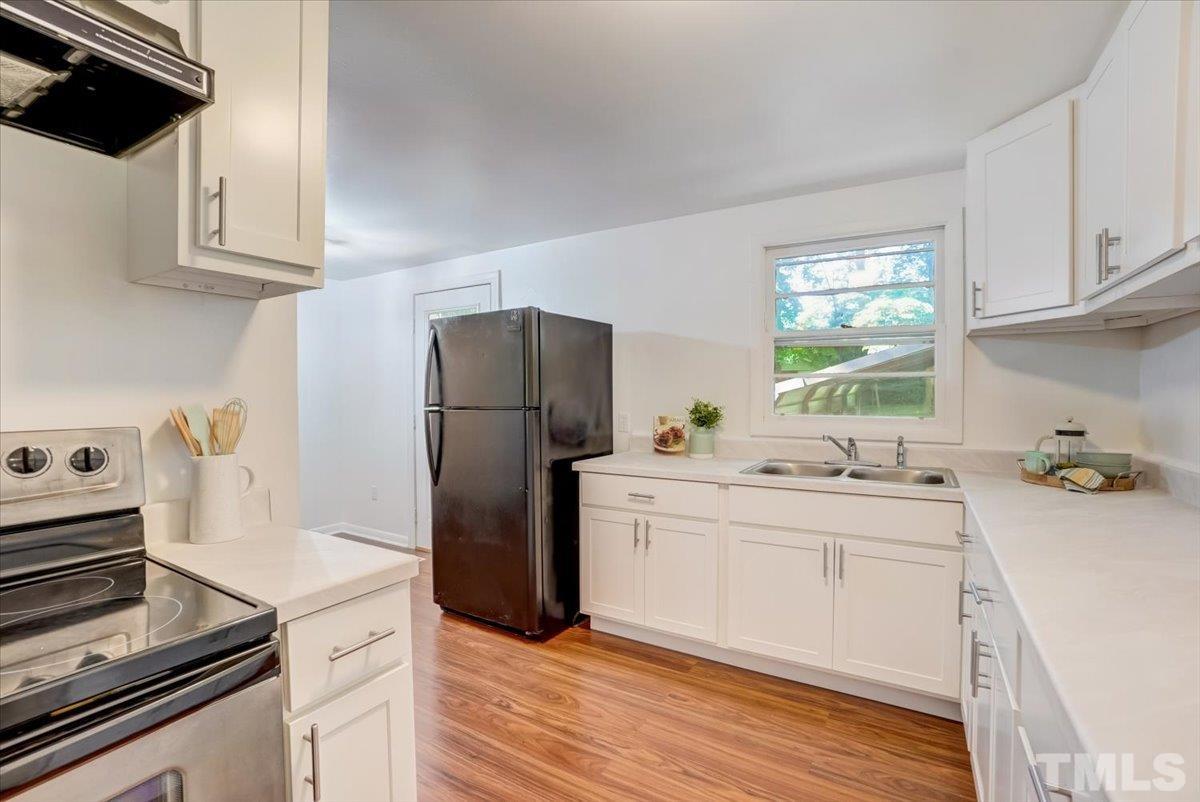 424 Grovemont Road Raleigh, NC 27603 - Photo 10 of 23 a kitchen with a sink cabinets and stainless steel appliances