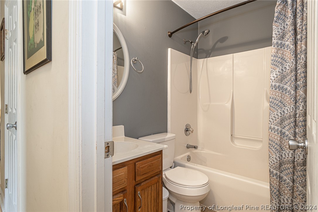 1955 Christopher Way Fayetteville, NC 28303 - Photo 16 of 35 a bathroom with a granite countertop sink toilet and shower