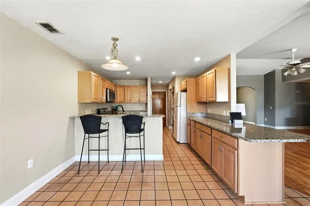 an empty room with windows and view of wooden floor