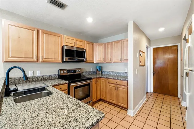 a kitchen with a stove and a microwave