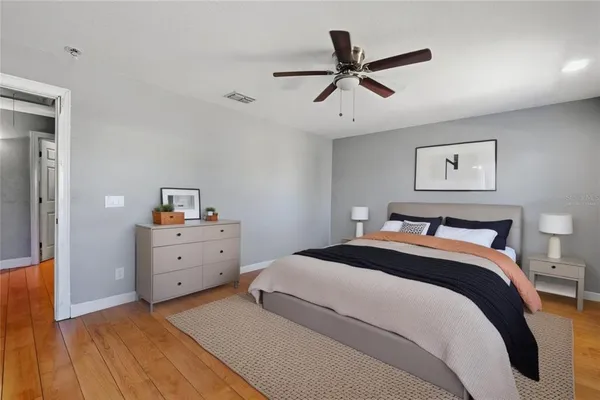 a bedroom with a bed chandelier and window