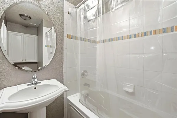 a bathroom with a granite countertop sink toilet and a mirror