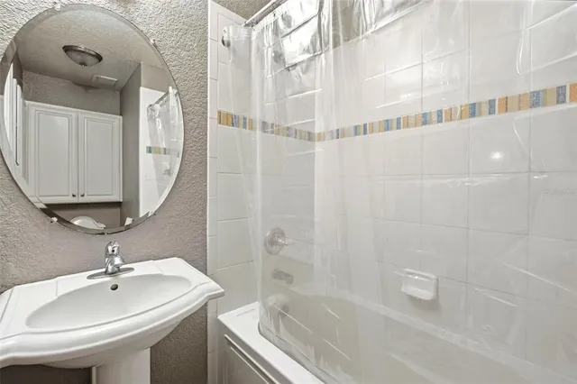 a bathroom with a granite countertop sink toilet and a mirror
