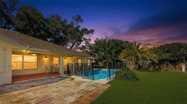 a view of a field with an trees in the background
