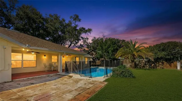 a view of a field with an trees in the background
