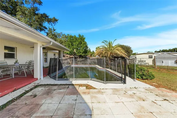 a dining room with furniture and a floor to ceiling window