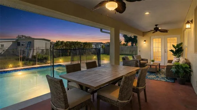 a view of a patio with a table chairs and a backyard