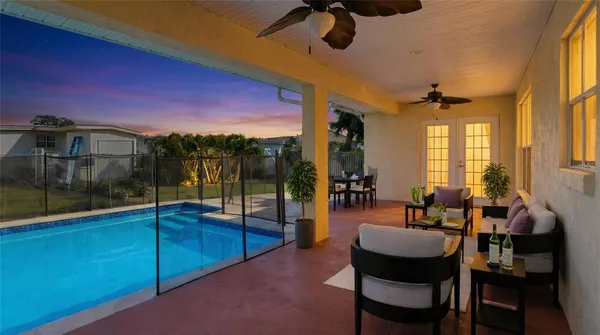 a view of a house with a yard and potted plants
