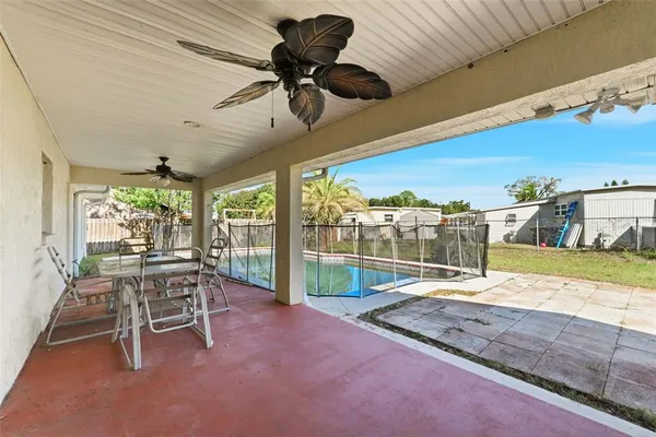 front view of a house with a tree in the grass