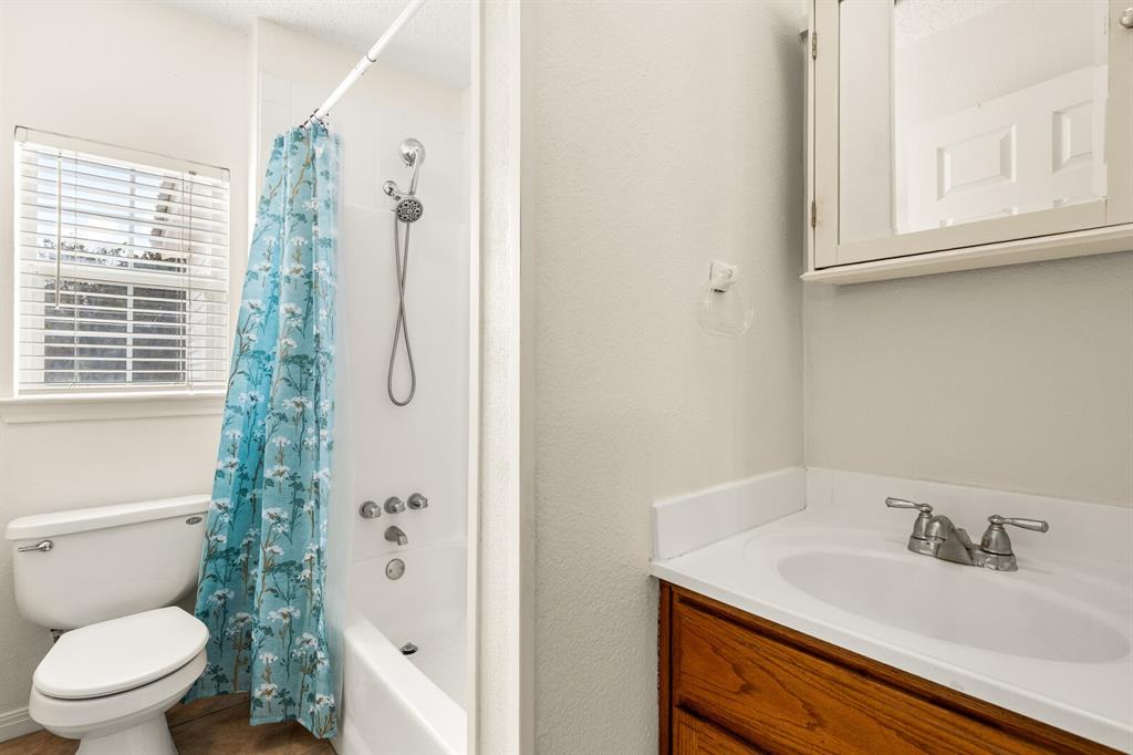375 Panther Branch Road Valley Mills, TX 76689 - Photo 14 of 34 a bathroom with a granite countertop sink a toilet and shower