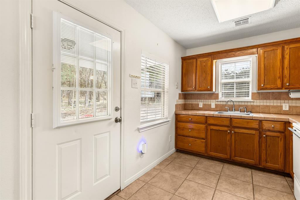 375 Panther Branch Road Valley Mills, TX 76689 - Photo 5 of 34 a kitchen with stainless steel appliances granite countertop a sink and cabinets