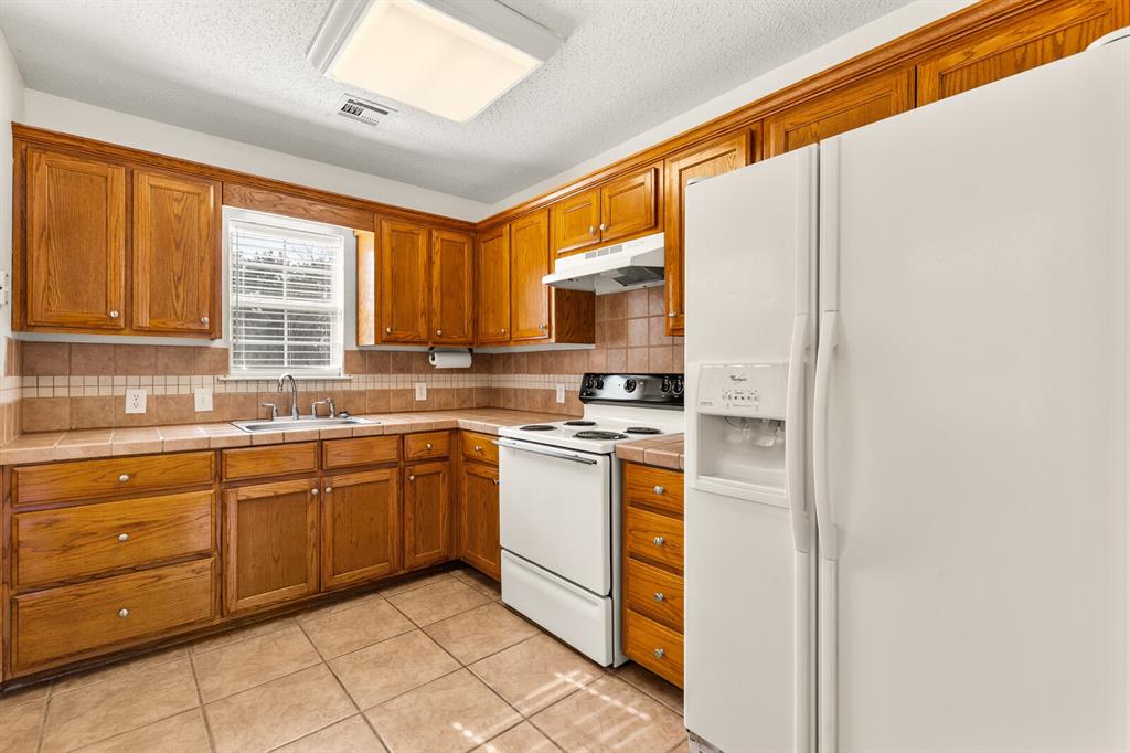375 Panther Branch Road Valley Mills, TX 76689 - Photo 6 of 34 a kitchen with stainless steel appliances granite countertop a stove a sink and a microwave