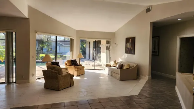 a living room with furniture and large windows