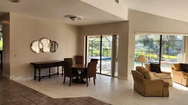 a view of a livingroom with furniture and a large window