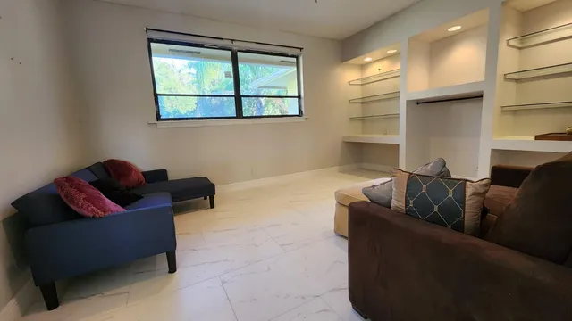 a living room with furniture and a window