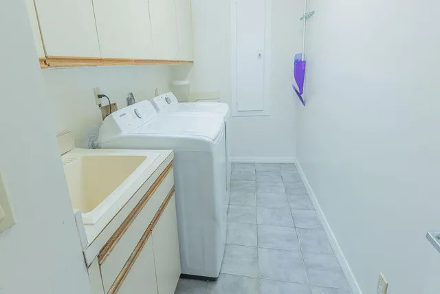 a bathroom with a sink and a washer dryer