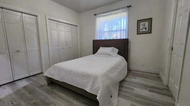 a bedroom with a bed and a window