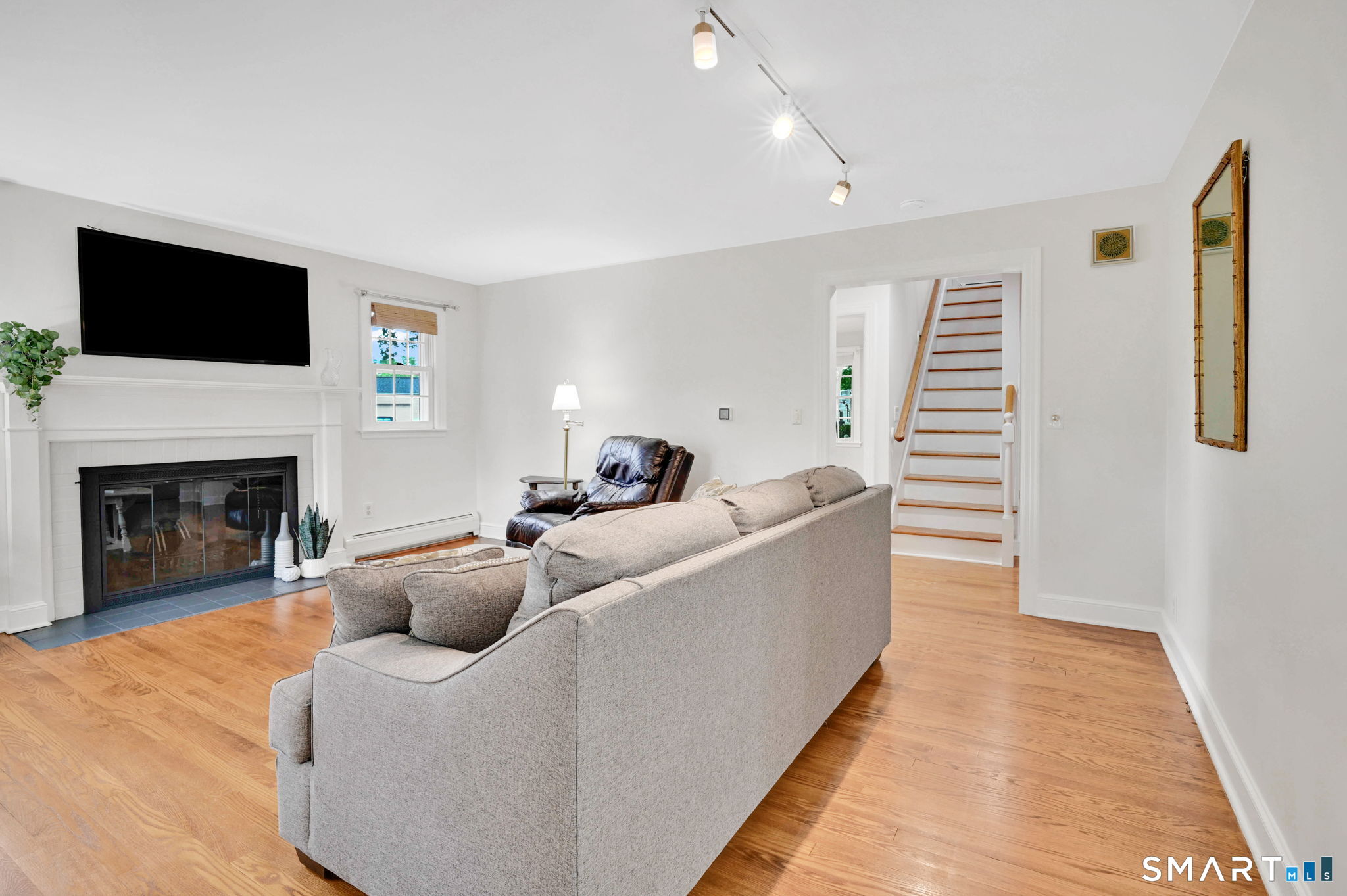 35 S Road Enfield, CT 06082 - Photo 8 of 40 Living room with hardwood floors and fireplace.