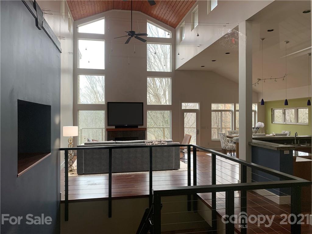 8060 Summit Ridge Drive Catawba, NC 28609 - Photo 7 of 32 a dining room with wooden floor a chandelier a glass table and chairs