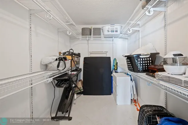 a bathroom with a toilet sink vanity granite and shower