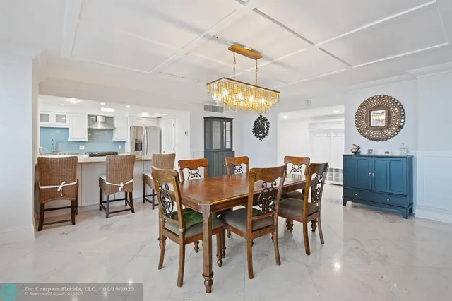 a living room with furniture and large windows