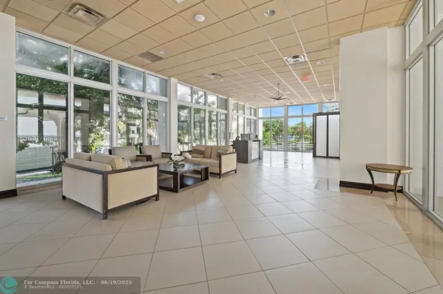 a view of a building with pool and sitting area