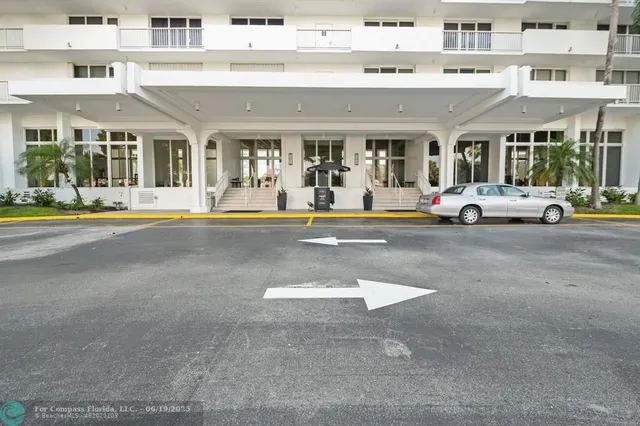 a view of a garden with flowers and trees