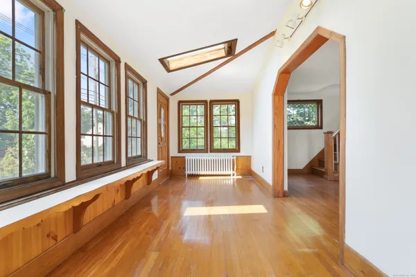 a view of an entryway with wooden floor