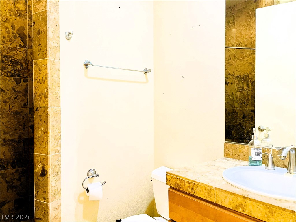 360 East Desert Inn Road, Unit 507 Las Vegas, NV 89109 - Photo 26 of 37 Elegantly tiled surfaces surround this functional vanity area.