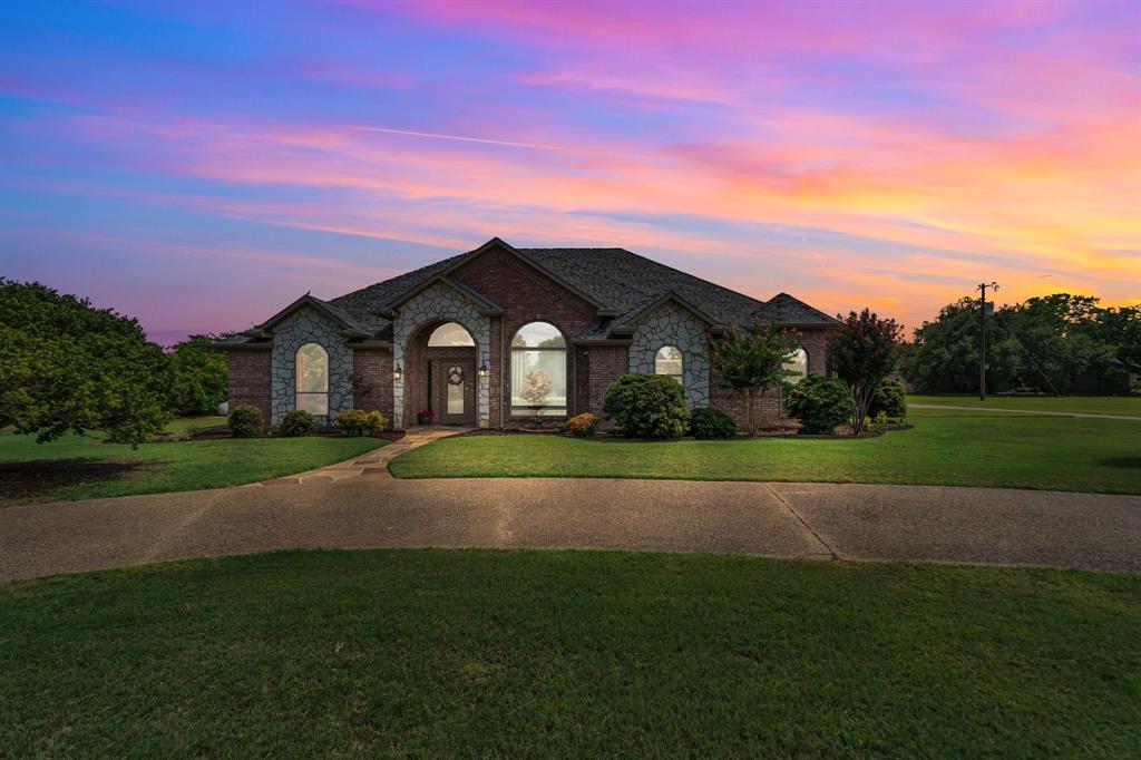 50 Buckingham Lane Allen, TX 75002 - Photo 2 of 39 French country inspired facade with a yard, brick siding, and stone siding