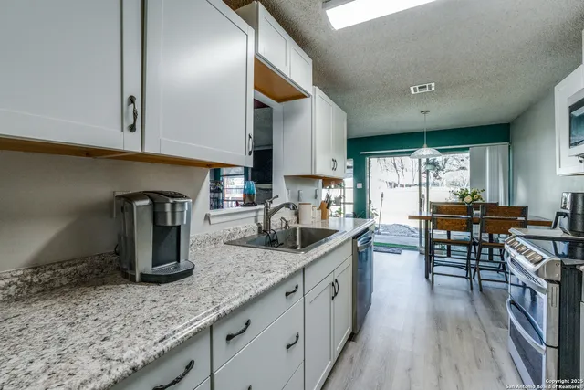 a dining room with furniture wooden floor and a rug