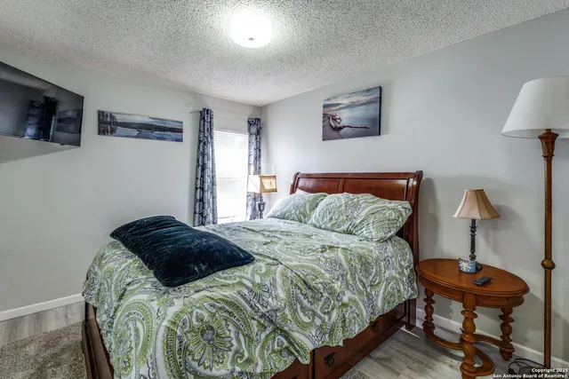 a bathroom with a granite countertop sink a mirror and a shower