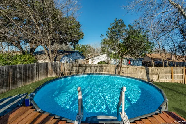 a view of a house with backyard sitting area and garden