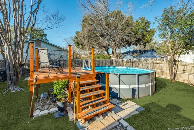 a view of an house with backyard space and balcony