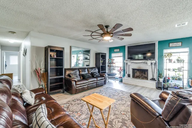 a living room with furniture a fireplace and a flat screen tv