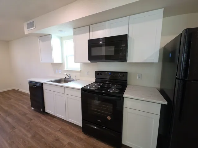 a kitchen with a sink stove and microwave