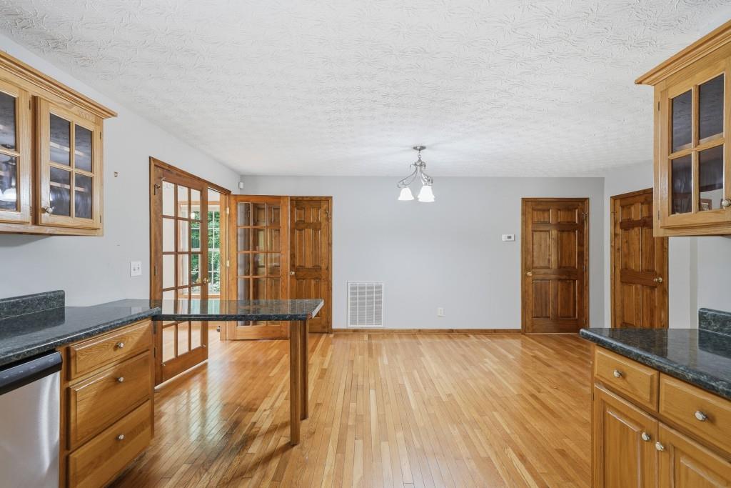 176 Big Oak Tree Road Northwest Adairsville, GA 30103 - Photo 21 of 77 a view of empty room with wooden floor and fan