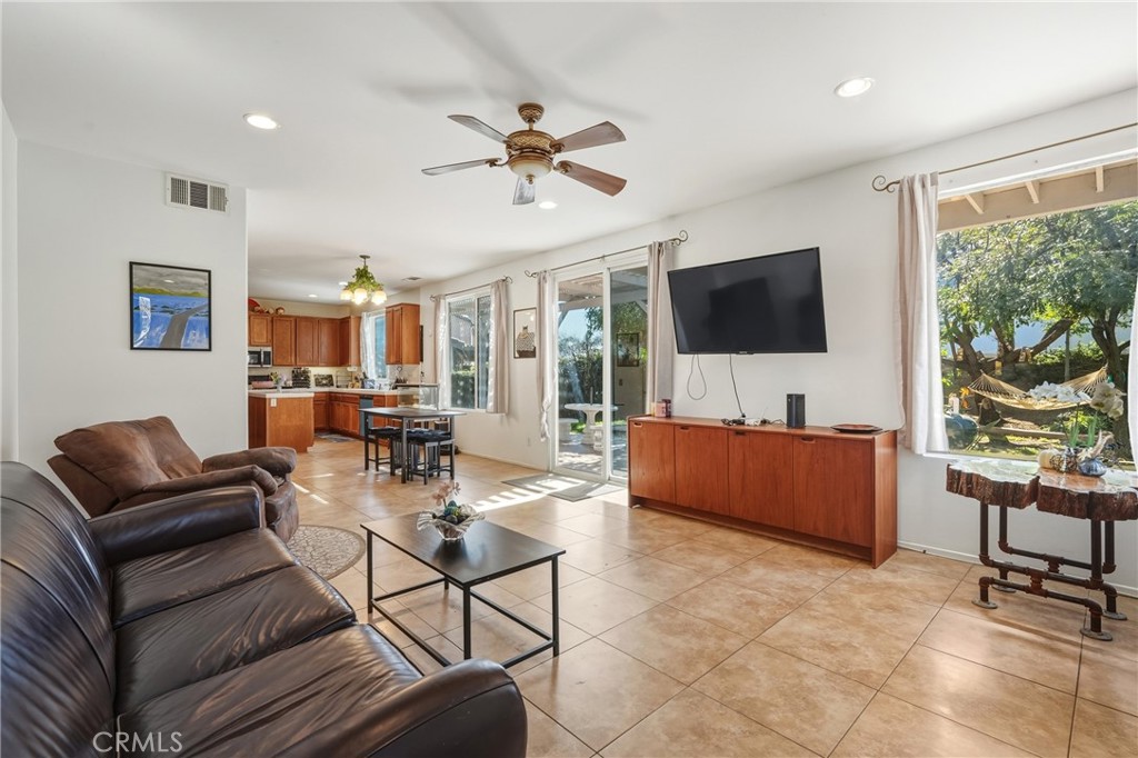 28853 Galaxy Way Menifee, CA 92586 - Photo 13 of 36 a living room with furniture a flat screen tv and a large window